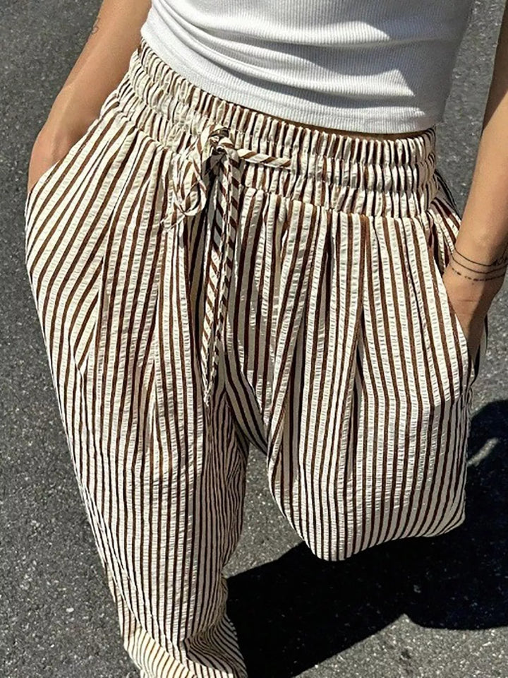 Close-up of the brown striped pants gathered waist and drawstring bow