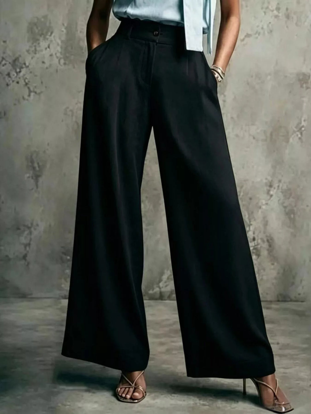 Black high waist wide leg trousers worn with heeled sandals