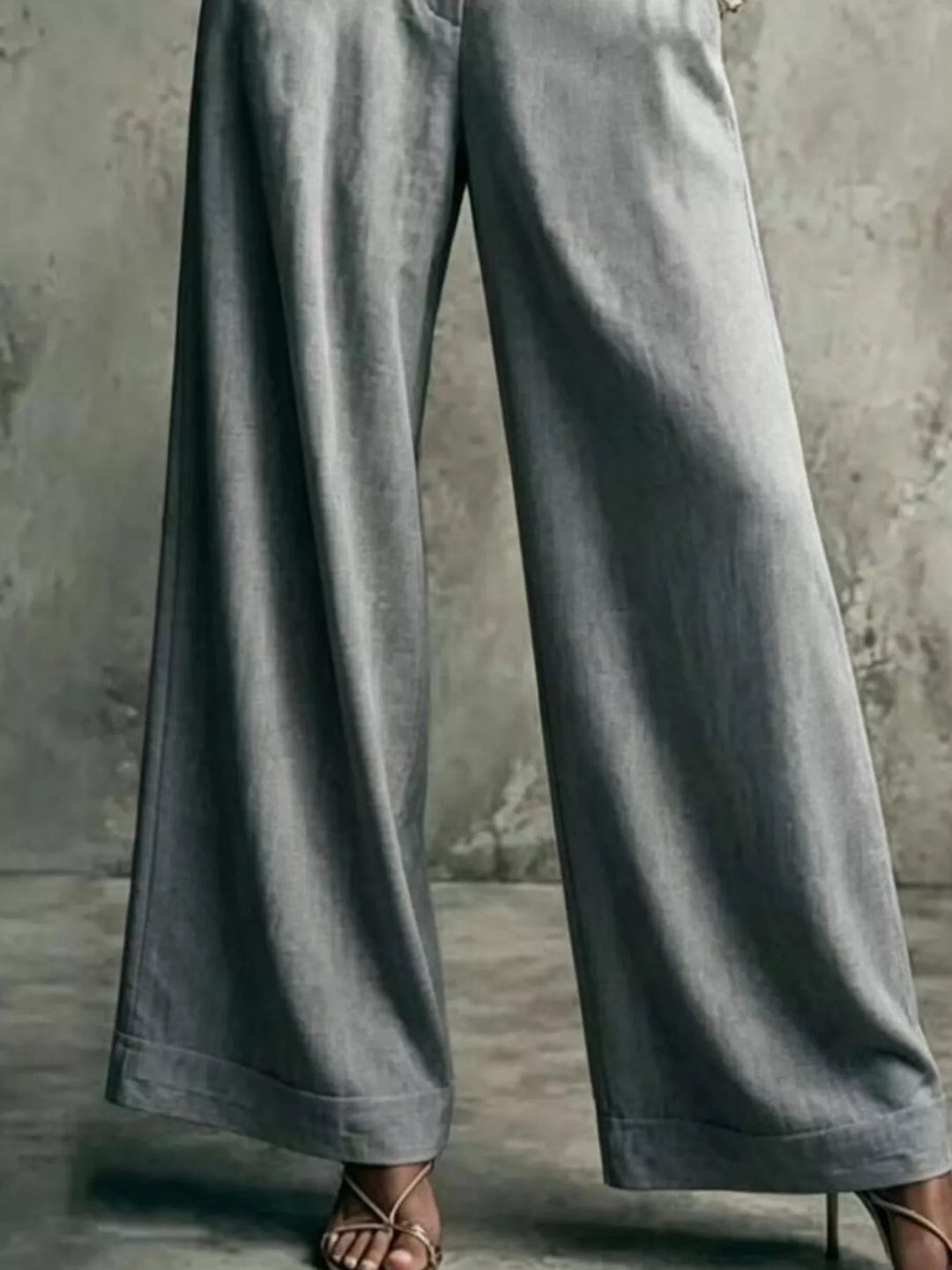 Gray wide leg trousers showing the long flowing leg, lower body view
