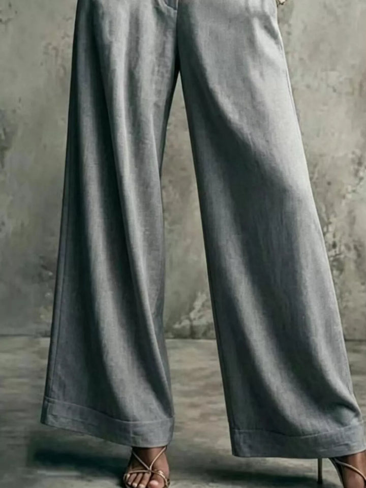 Gray wide leg trousers showing the long flowing leg, lower body view