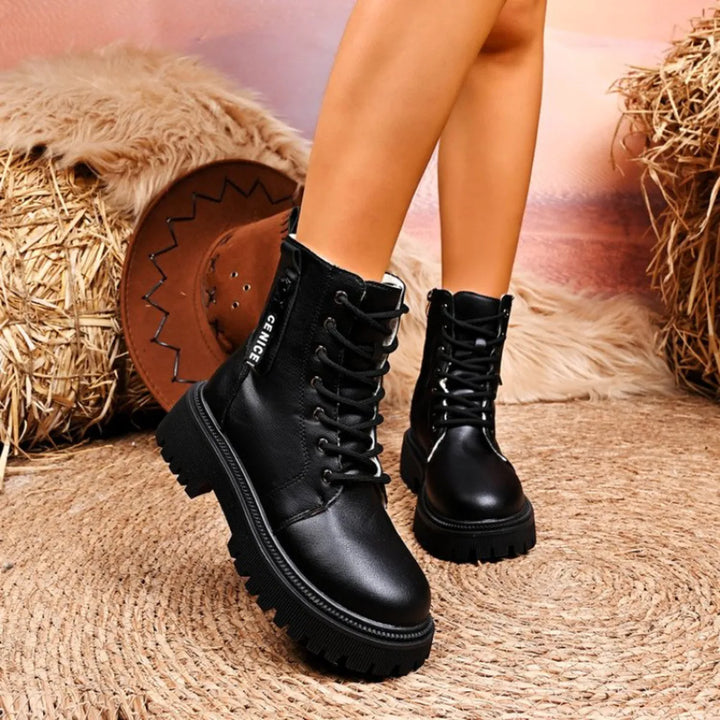 Pair of black lace up platform winter boots with chunky sole
