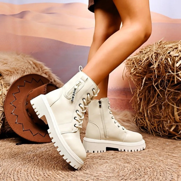 Ivory ankle boot with chain detail and side zipper close up