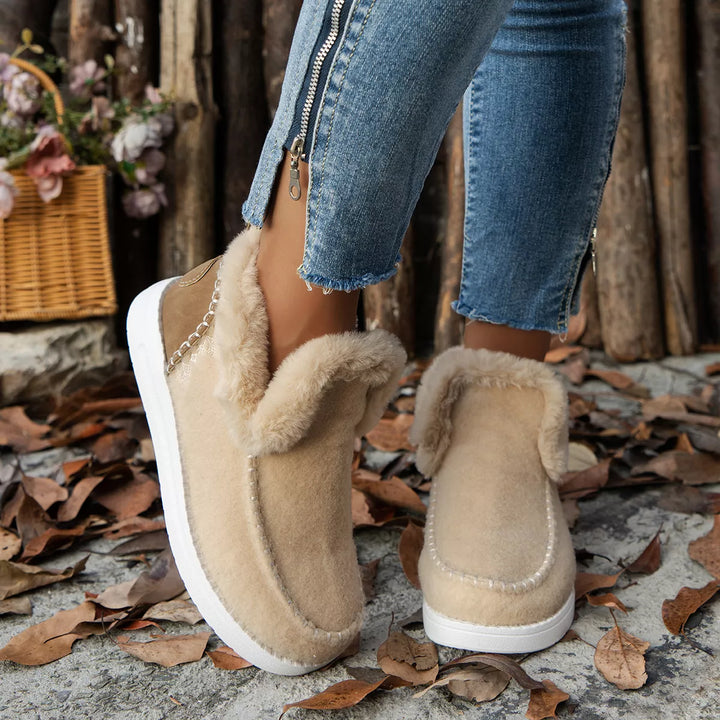 Beige slip on ankle boots with plush collar worn with cuffed jeans