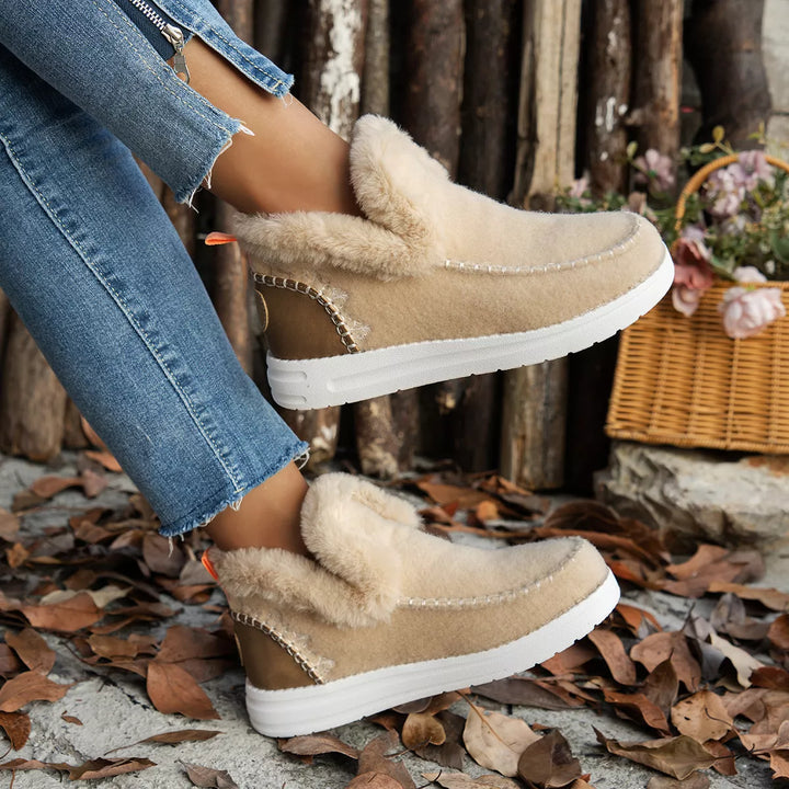 Beige slip on winter boot in side profile with fluffy collar