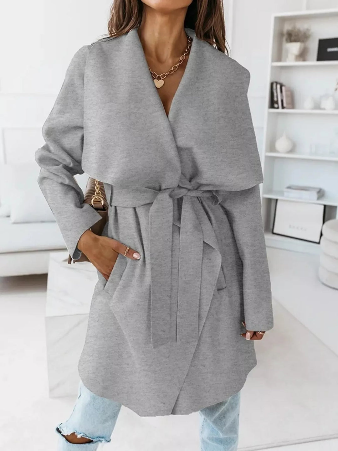 Gray winter coat with belted waist and wide shawl lapel, front view