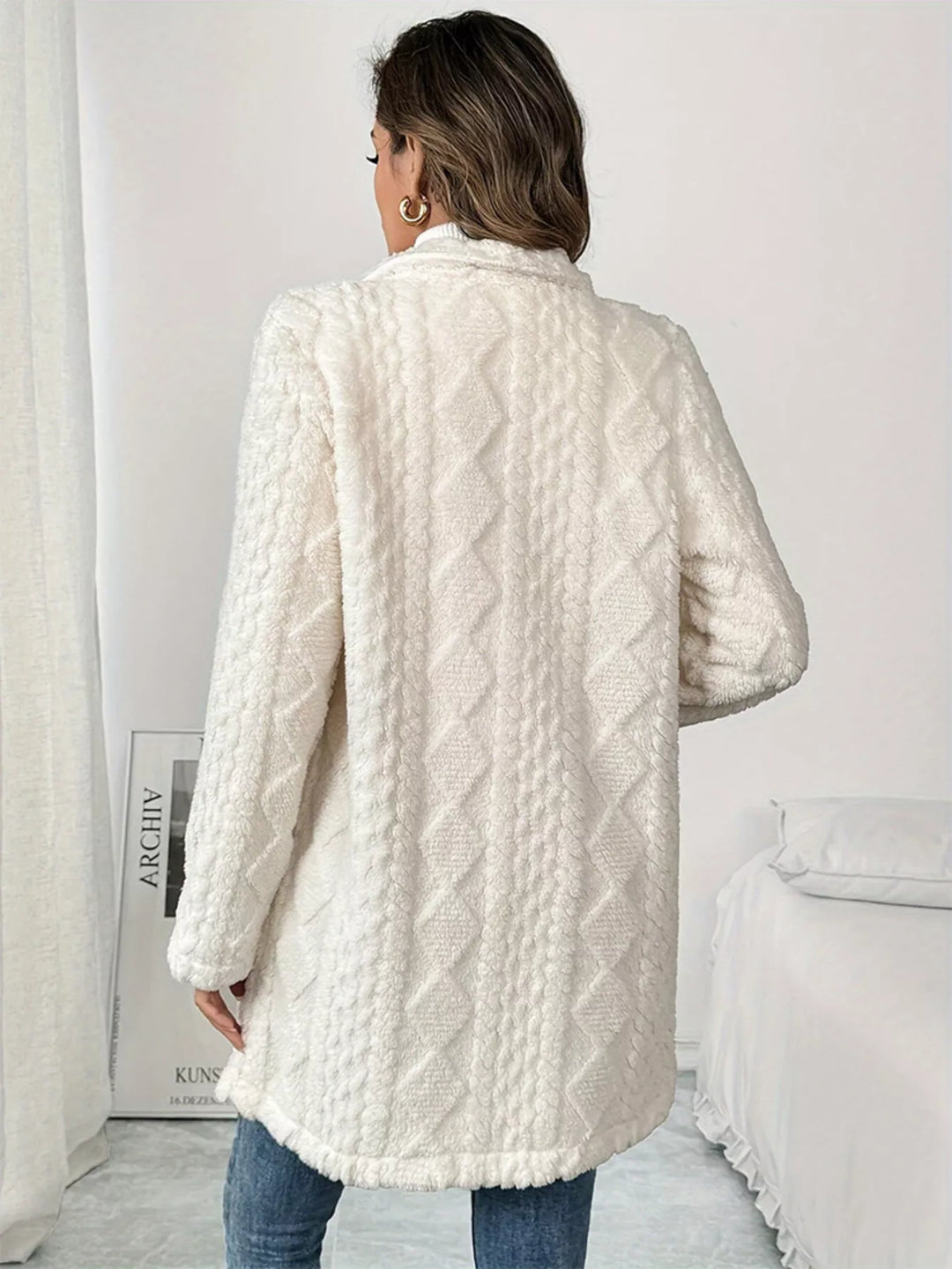 Back view of the ivory longline coat showing the diamond quilted texture