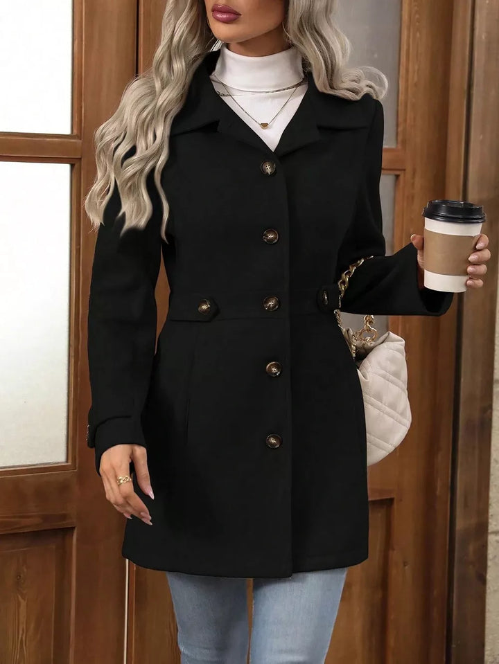 Black fitted button up coat front view with a coffee cup
