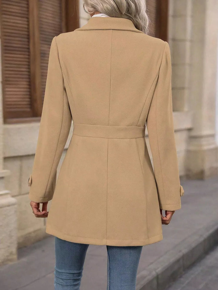 Back view of the camel winter coat with a defined waist seam