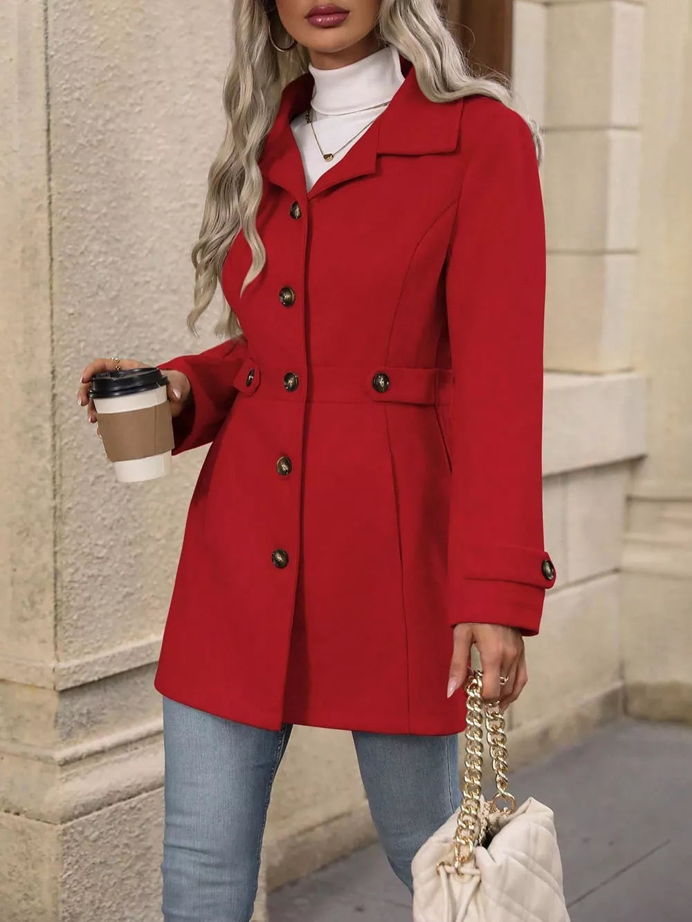 Red winter coat full length view with belted waist and chain strap bag