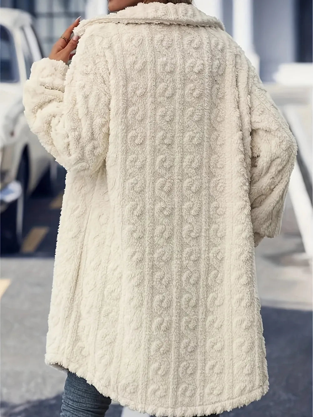 Back view of the cream fuzzy longline coat showing the textured pattern