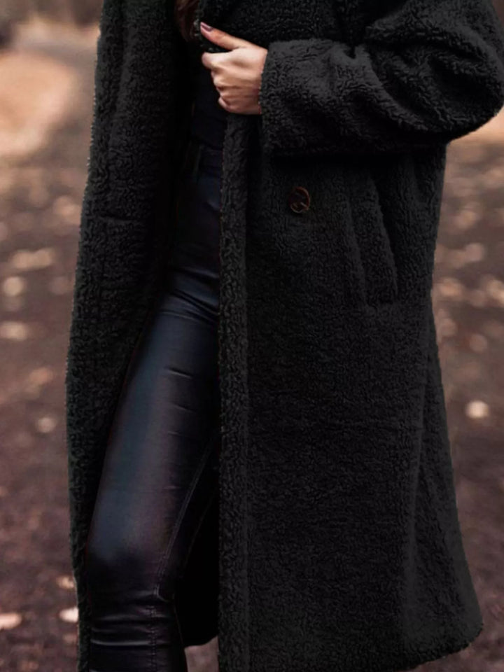 Black longline open front coat showing the pocket and skirt length