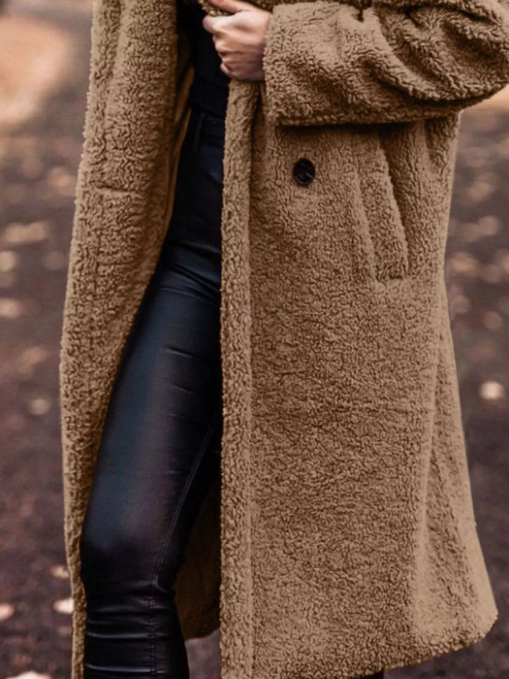 Camel longline open front coat showing the pocket and skirt length