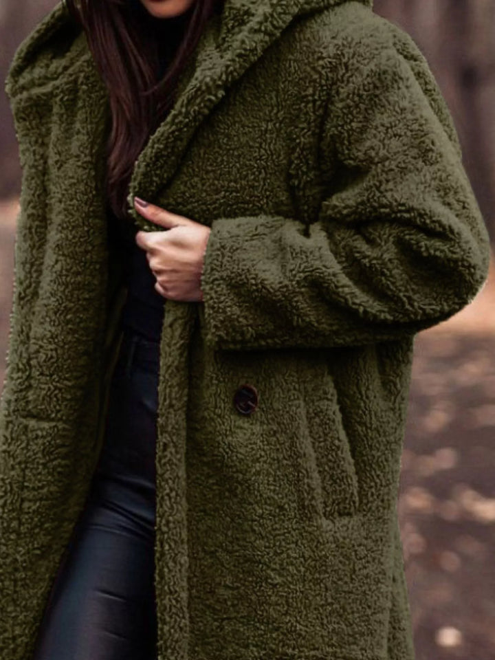Olive longline open front coat showing the pocket and skirt length