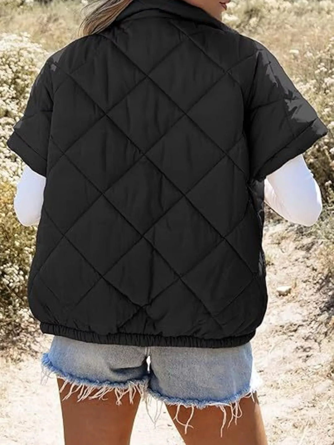Diamond quilted short sleeve zip in black, back view