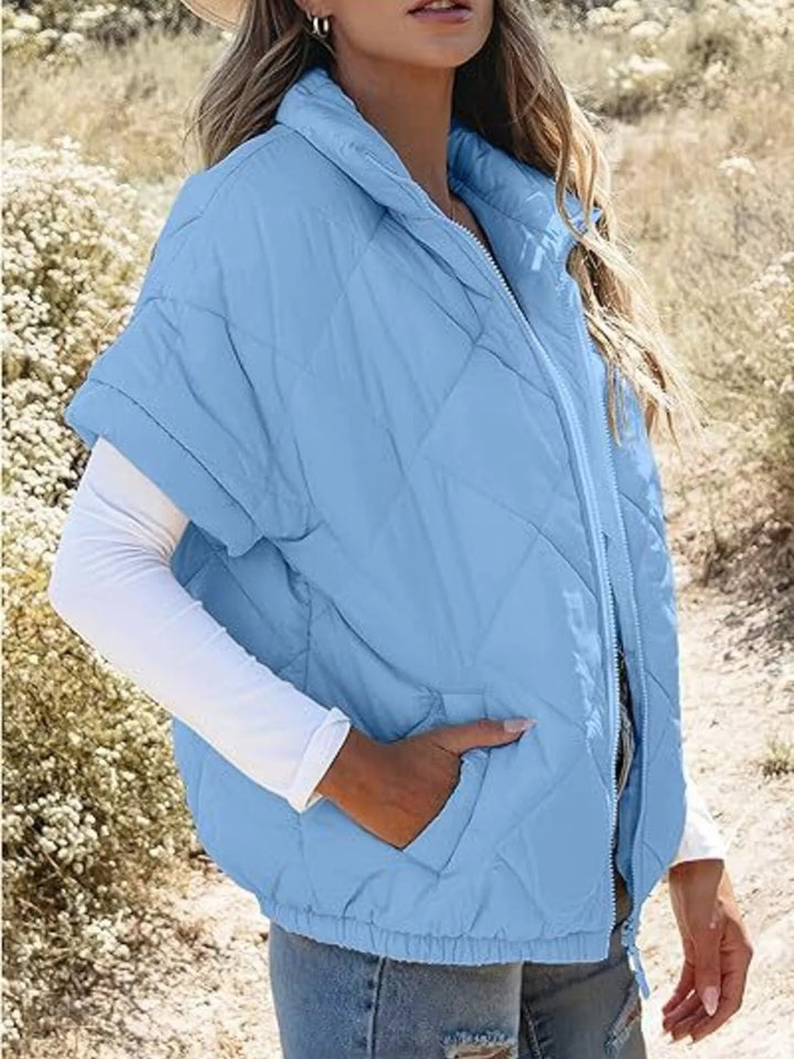 Diamond quilted short sleeve zip in sky blue, styled on model